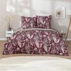A bed with burgundy paisley-patterned bedding is shown in a bedroom setting. Produktbild-Vorschau