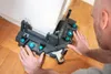A person is using a miter box tool in a room with wooden flooring and a white wall. Produktbild-Vorschau