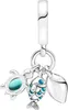 A silver charm with three dangling pendants: a turtle with a blue gem, a fish with blue scales, and a shell. Anteprima dell’immagine prodotto