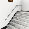A stainless steel handrail runs along a staircase with marble-like steps. Produktbild-Vorschau