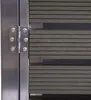 A close-up view of a metal hinge and a section of a dark gray WPC trash can enclosure. Náhled obrázku produktu