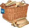 A wicker basket filled with firewood, with a pile of firewood in front of it. Náhled obrázku produktu