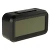 A black digital alarm clock with a large LCD screen and a snooze/light button on top, shown against a white background. Náhled obrázku produktu