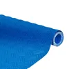 A rolled-up blue mat with a textured surface, shown diagonally against a white background. Produktbild-Vorschau