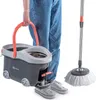A person is holding a spin mop bucket and a spin mop is next to them. Voir les images du produit