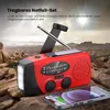 A red emergency radio with a solar panel and LED flashlight is placed on a rocky surface, with a smartphone charging from it. Produktbild-Vorschau