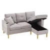 A light gray sectional sofa with its storage ottoman open, revealing the storage compartment. The sofa has a cup holder on one armrest and a small decorative pillow. Náhľad obrázku produktu