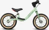 A light green balance bike with black handlebars and seat, and tan tires, is shown against a white background. Produktbild-Vorschau