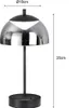A modern black table lamp with a reflective, dome-shaped shade, shown with dimensions indicated. Produktbild-Vorschau