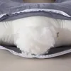 A close-up view of a pillow with its cover partially open, revealing the filling. Náhled obrázku produktu