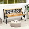 A garden bench on a patio with a window and plant in the background. Produktbild-Vorschau