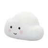 A white cloud-shaped night light with a smiling face. Voir les images du produit