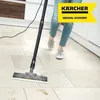 A person is using a steam cleaner on a tiled floor in a kitchen. Produktbild-Vorschau