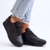 A person wearing black sneakers and ripped jeans. Produktbild-Vorschau