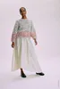 A woman modeling a sweater and skirt. Produktbild-Vorschau