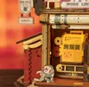 A close-up of a wooden model of a factory with a small elf-like character. Podgląd zdjęcia produktu