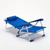 A blue folding beach chair with a pillow, shown on a white background. Voir les images du produit