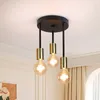 A close-up shot of a black and gold ceiling light fixture with three exposed bulbs, mounted on a white ceiling. Náhľad obrázku produktu