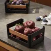Two storage crates filled with fruit on a kitchen counter. Produktbild-Vorschau