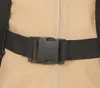 A close-up of a black plastic buckle and strap on a beige fabric. Náhled obrázku produktu