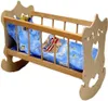 A wooden doll's cradle with blue bedding featuring stars and a teddy bear. Náhľad obrázku produktu