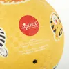 A close-up of a yellow ball with cartoon animal graphics and brand logos. Produktbild-Vorschau