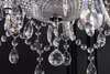 A close-up view of a crystal chandelier with many hanging prisms and beads. Náhled obrázku produktu