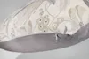 A close-up view of a pillow cover with a floral pattern and a zipper. Produktbild-Vorschau