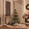A Christmas-themed room with a decorated tree, fireplace, and presents. Náhľad obrázku produktu