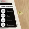 A gold-colored door handle is shown mounted on a wooden door, with a graphic overlay detailing the included components of the door handle set. Produktbild-Vorschau