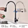 A black kitchen faucet is shown in use, with a hand rinsing a green fruit under the water stream. The faucet is flexible and can rotate 360 degrees. Icons and text describe its features. Podgląd zdjęcia produktu