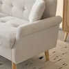 A close-up view of a beige sofa armrest and cushion. Anteprima dell’immagine prodotto