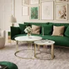 A living room scene with a green sofa, coffee tables, and artwork on the wall. Produktbild-Vorschau