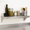 A stainless steel shelf mounted on a tiled wall, holding kitchen items. Podgląd zdjęcia produktu