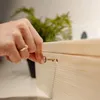 A hand is inserting a small key into a wooden box. Náhled obrázku produktu