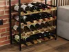 A metal wine rack filled with wine bottles, placed against a brick wall. Podgląd zdjęcia produktu