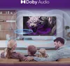 A family is sitting on a couch watching a TV that displays a tiger image. Sound waves are depicted around the TV. Podgląd zdjęcia produktu