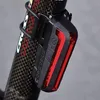 A close-up shot of a bicycle tail light attached to a carbon fiber bicycle frame. Podgląd zdjęcia produktu