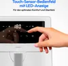A hand is shown interacting with the touch-sensitive control panel of a white air fryer, which displays the temperature "180". Produktbild-Vorschau