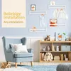 A nursery or child's room with a blue armchair, shelves, and toys. Náhľad obrázku produktu