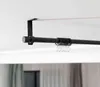 A black curtain rod mounted on a white ceiling with curtain rings attached. Produktbild-Vorschau