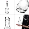 A collage of four images showing a clear glass bottle with a cork, its base, its neck, and a person holding the bottle. Anteprima dell’immagine prodotto