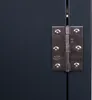 A close-up view of a metal hinge on a dark gray surface, possibly a door or cabinet. Náhled obrázku produktu