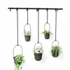 Five hanging planters with plants on a white background. Produktbild-Vorschau