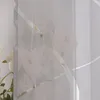A close-up view of a sheer curtain with a floral pattern and decorative stripes. Produktbild-Vorschau