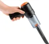 A hand holding a black and orange cordless handheld vacuum cleaner against a white background. Produktbild-Vorschau