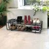 A shoe rack with various shoes on it, placed on a light-colored floor. Náhled obrázku produktu