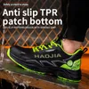 A person wearing a black and green safety shoe with water splashing on it. Produktbild-Vorschau