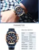 A man's wrist wearing a blue and gold watch, with a table of product specifications below. Produktbild-Vorschau