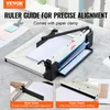 A paper cutter with a ruler guide and paper clamp, shown on a desk with some paper. Produktbild-Vorschau